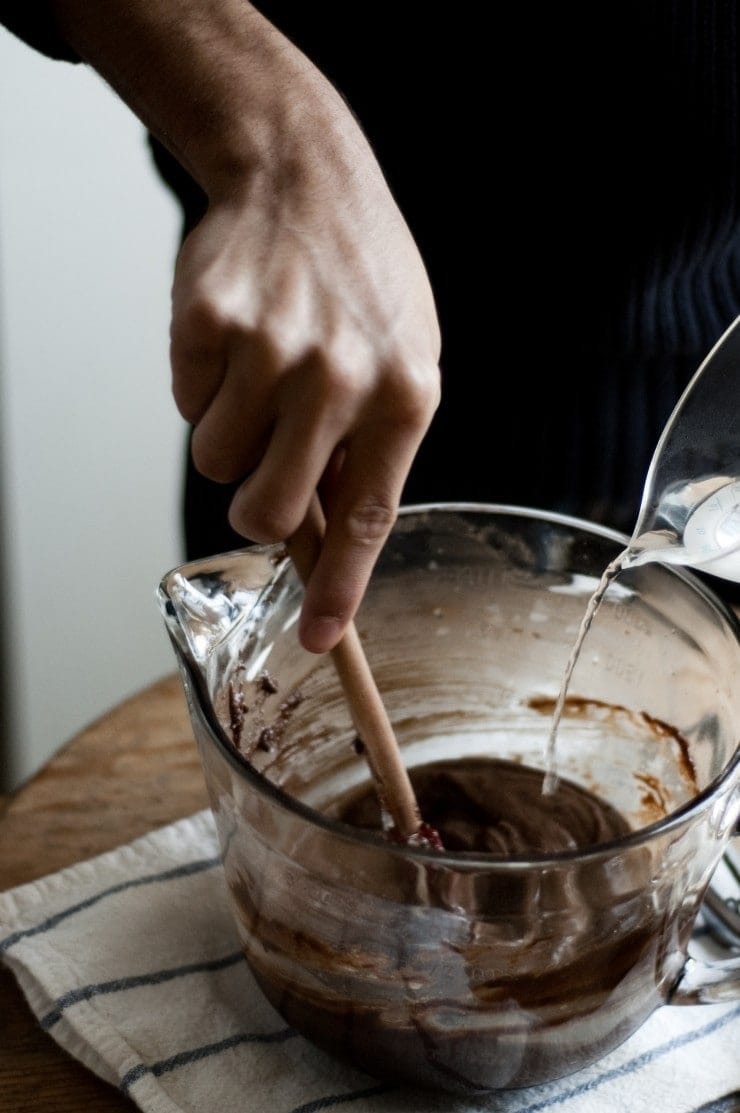 Mixing boiling hot water into chocolate cake batter