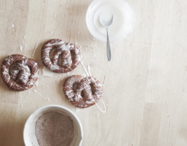 Glazed soft pretzels and bowl of cinnamon sugar