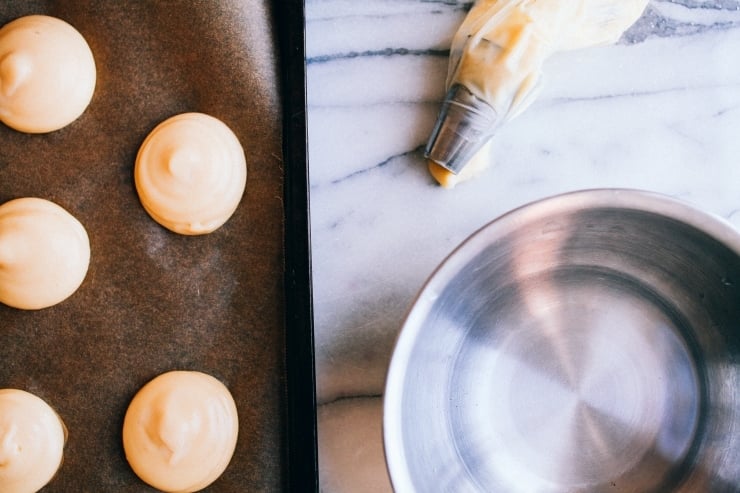 A recipe for perfect, light and airy, fool-proof profiteroles (cream puffs) topped with chocolate sauce. Classy and easy! | sophisticatedgourmet.com