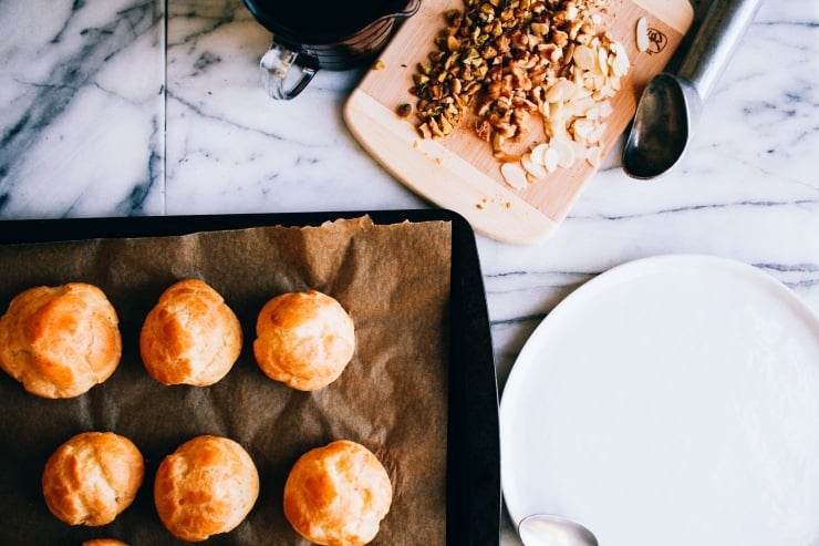 A recipe for perfect, light and airy, fool-proof profiteroles (cream puffs) topped with chocolate sauce. Classy and easy! | sophisticatedgourmet.com