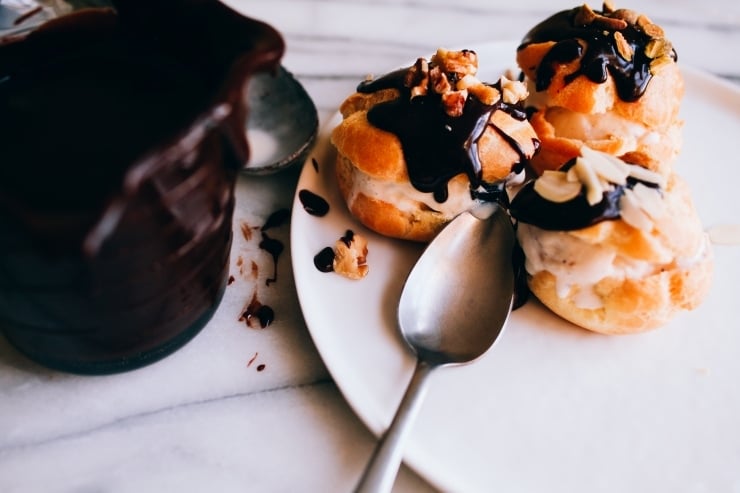 A recipe for perfect, light and airy, fool-proof profiteroles (cream puffs) topped with chocolate sauce. Classy and easy! | sophisticatedgourmet.com