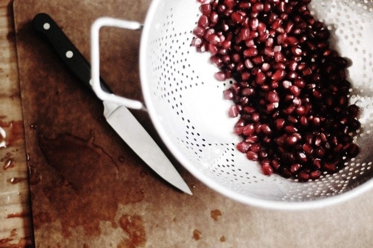 Pomegranate seeds in colander