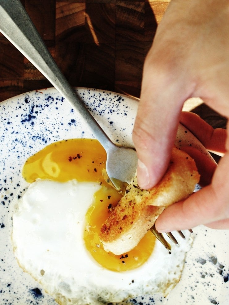 Dipping into a runny yolk fried egg